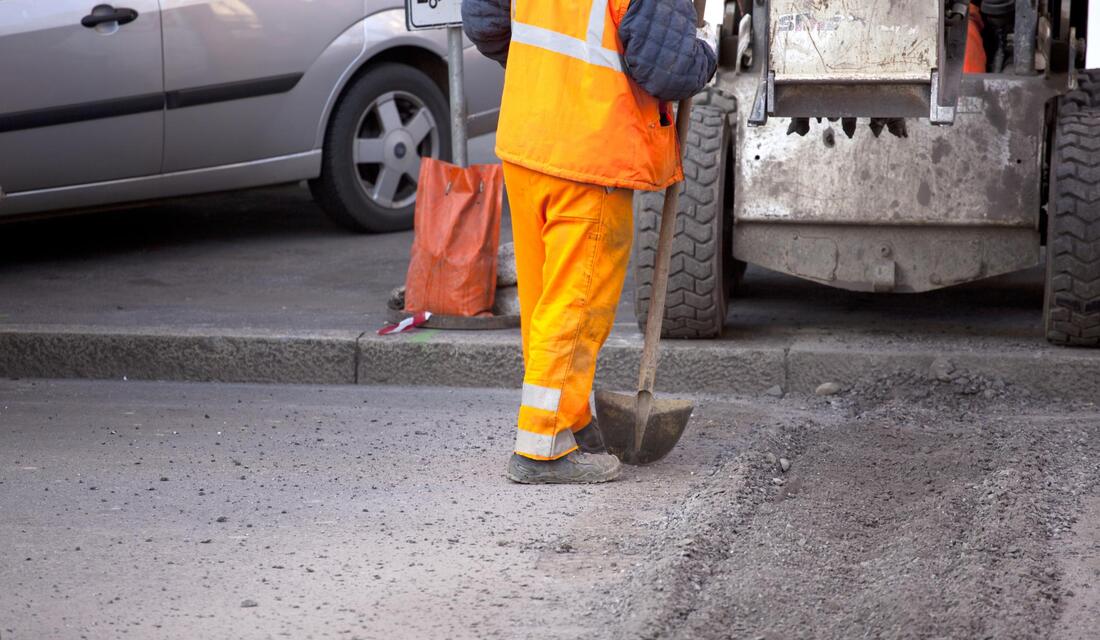 worker doing asphalt maintenance 